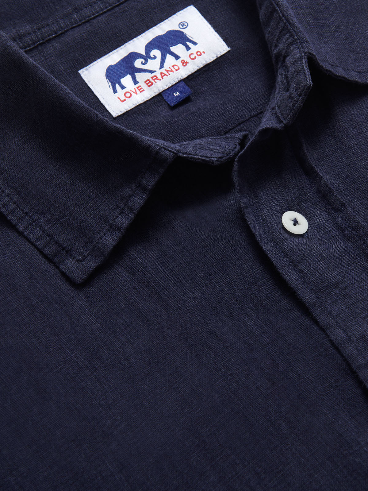 Abaco Navy Blue mens Linen Shirt close-up view. Mens linen shirt showing navy blue colour and love brand & co logo label.