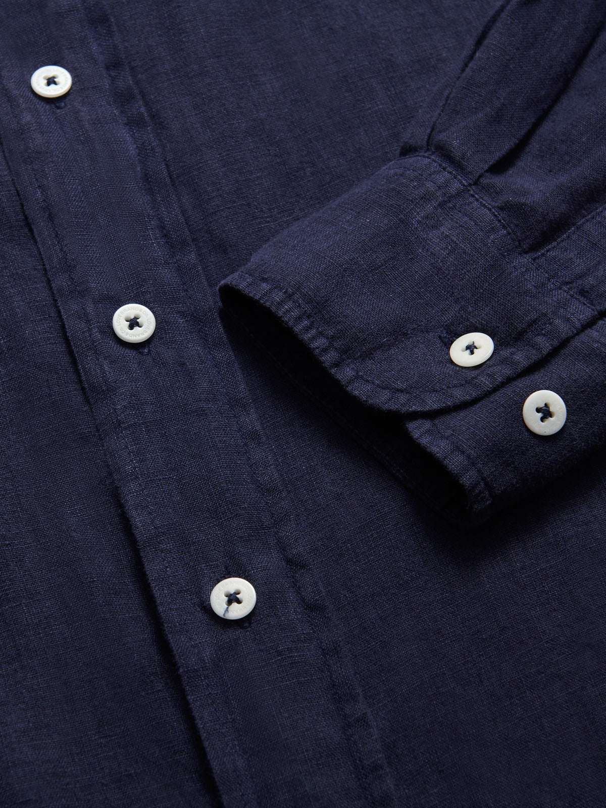 Close up of Abaco Navy Blue mens Linen Shirt. Showcasing coroo nut buttons and navy blue colour.