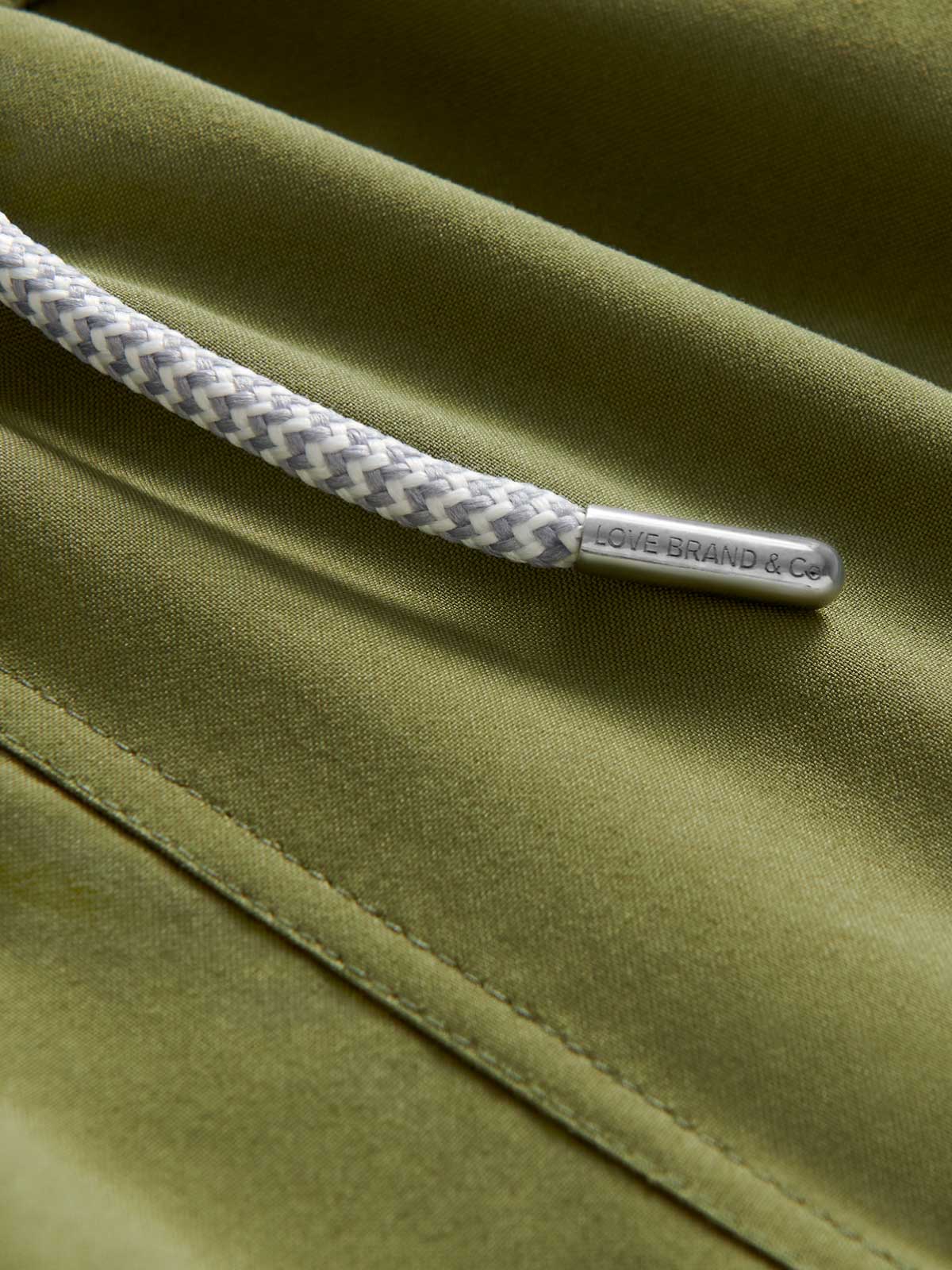 Detailed view of Boys Olive Green Staniel Swim Shorts showing drawstring.