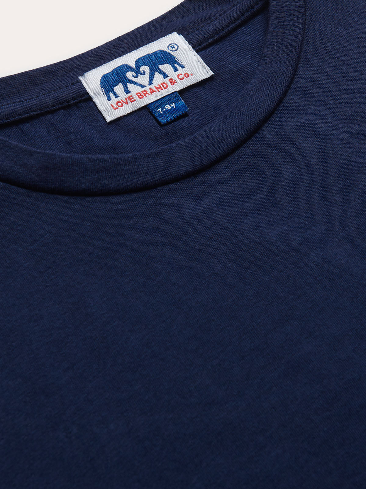 Detailed view of Kids Navy Blue Lockhart With Tab T-Shirt. Short sleeved blue t-shirt for children.