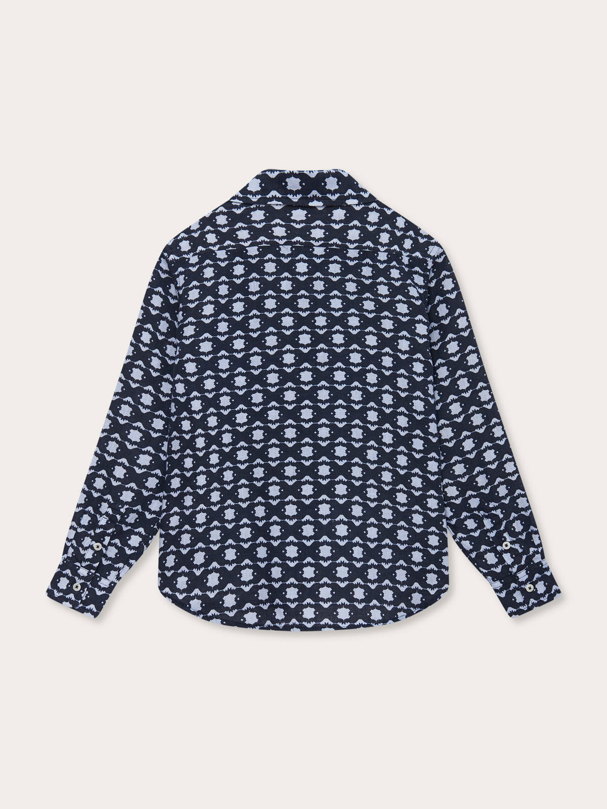 Back view of the Boys Rhino Rhythm Abaco Linen Shirt featuring a geometric rhino print in navy and sky blue, inspired by African wildlife conservation.