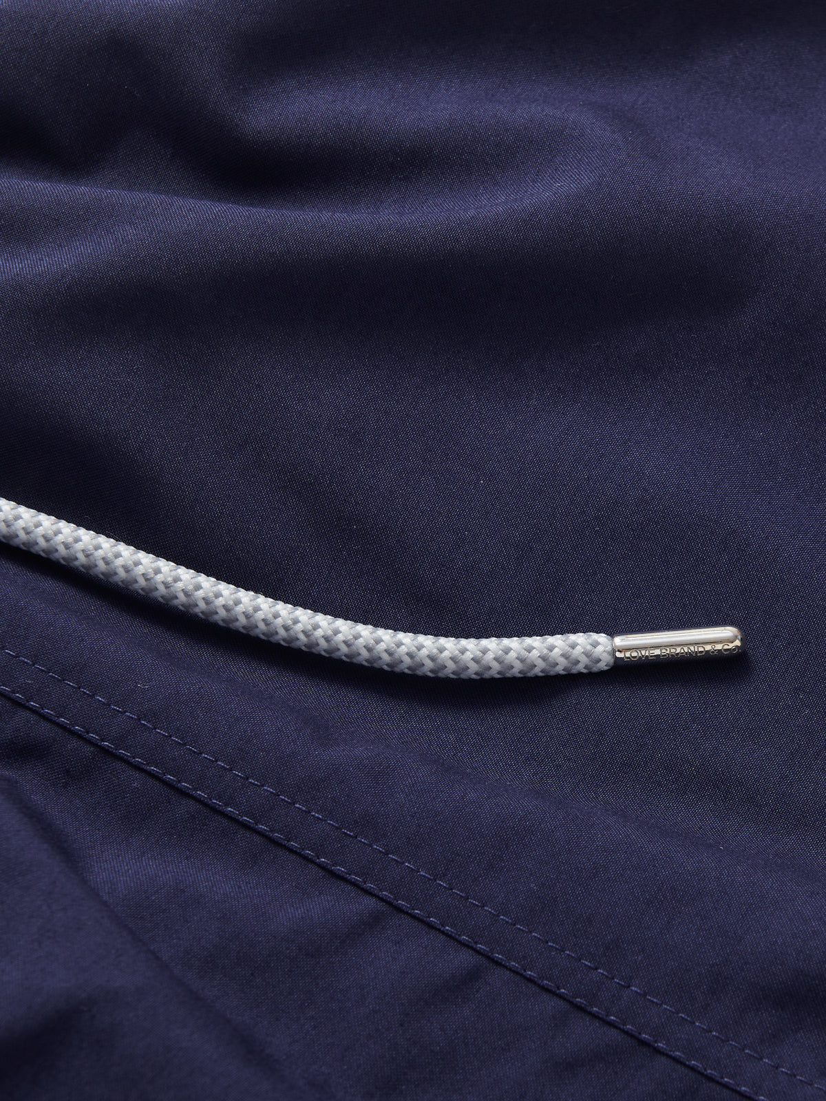 Detailed view of Boys Navy Blue Staniel Swim Shorts. Boys navy swim shorts with drawstring.