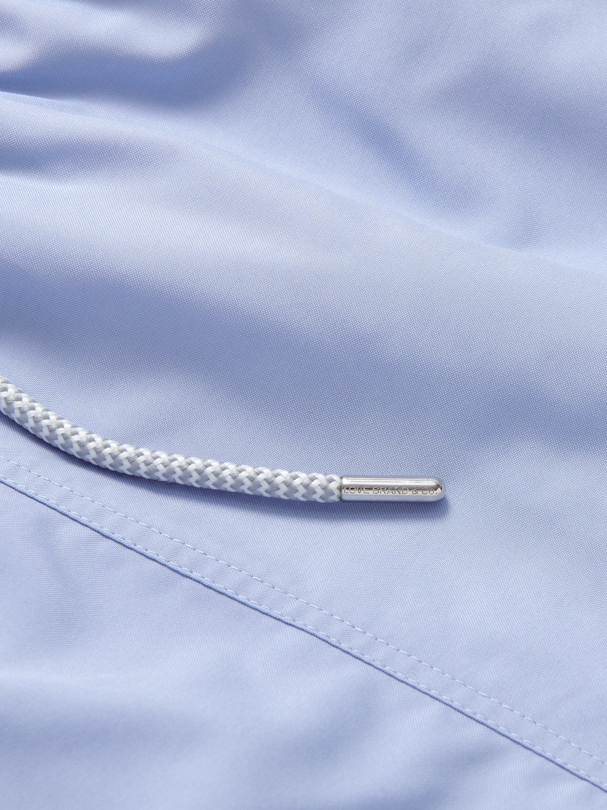 Close-up view of Boys Sky Blue Staniel Swim Shorts. Childrens sky blue swim shorts with pockets and a drawstring waist.