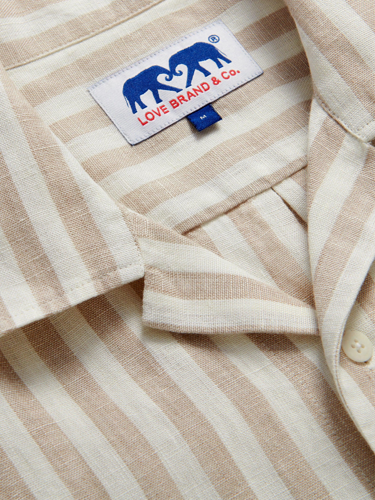 Close-up of Men’s Coconut Stripe Goat Linen Resort Shirt showcasing brown and white striped print.