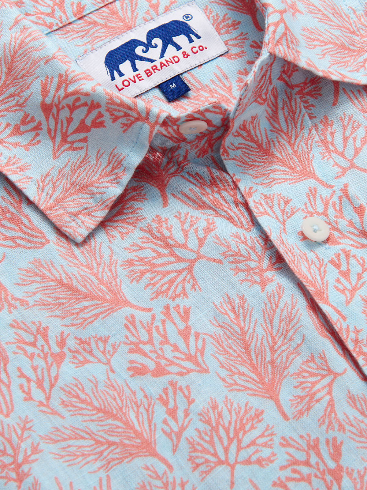 Crazy Coral Abaco mens Linen Shirt detailed view. Close up of a blue and coral mens linen shirt.