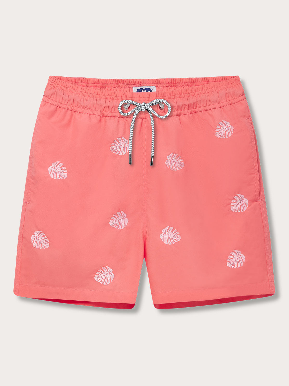 Men's Deliciosa Embroidered Staniel Swim Shorts in coral rose color with pink embroidered monstera leaves. Embroidered swim shorts featuring a drawstring waistband and quick-drying fabric.