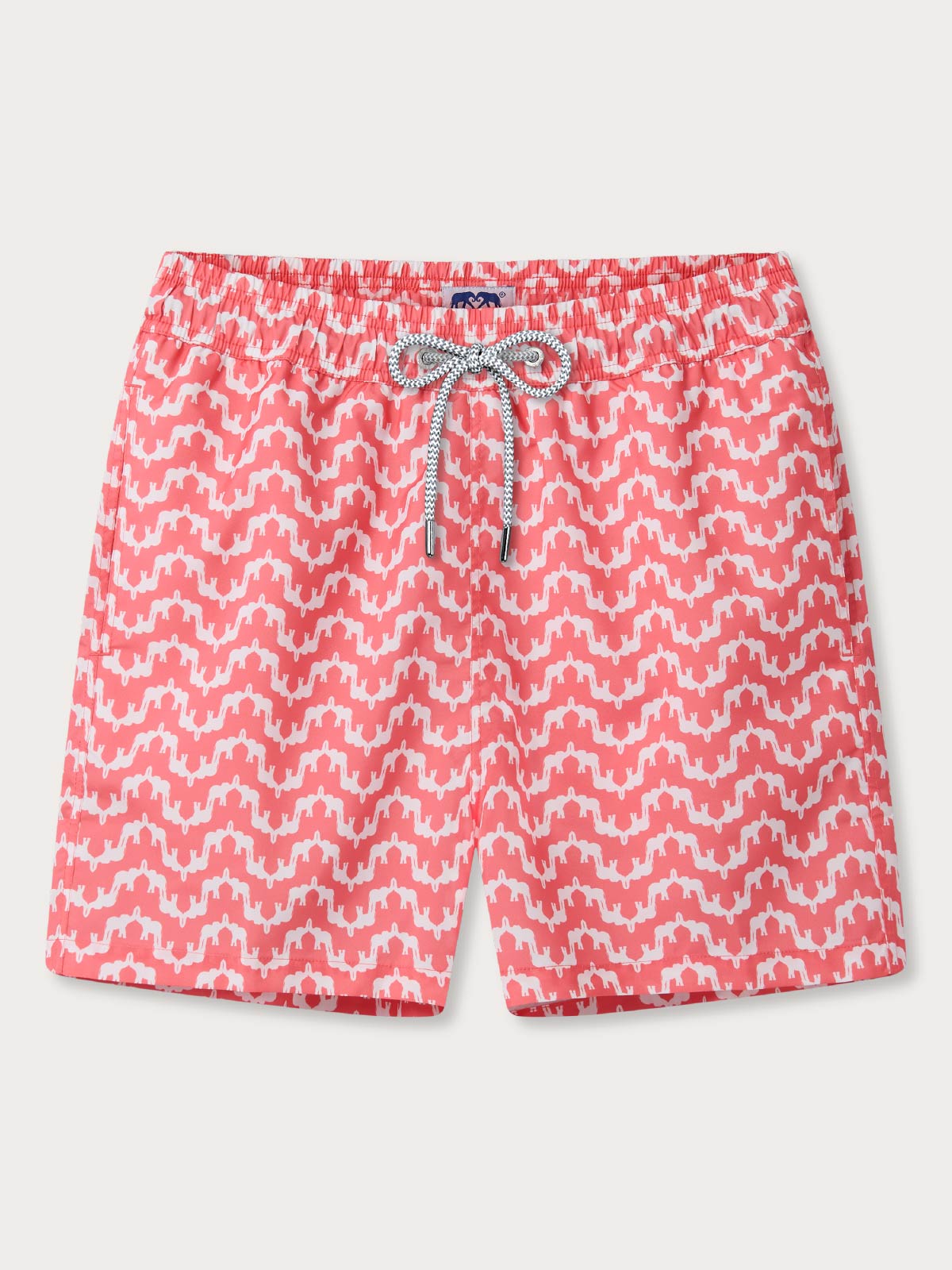 Red and white patterned swim shorts on a light grey background featuring hero elephant palace print