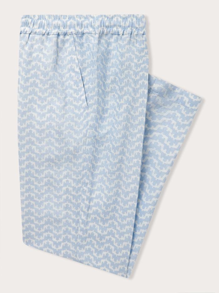 Old money style men's resort apparel. Side view of blue and white mens linen pants.