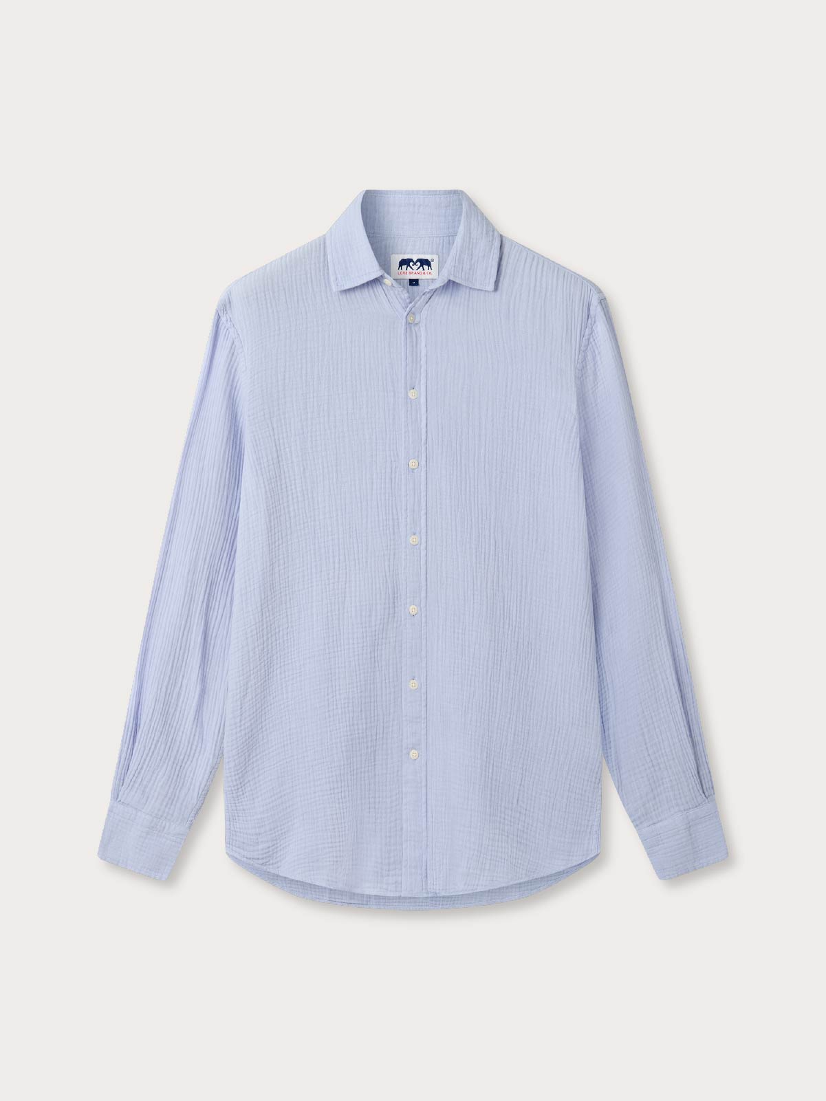 Sky blue shirt with long sleeves made from 100% cotton. Front view of shirt on white background.