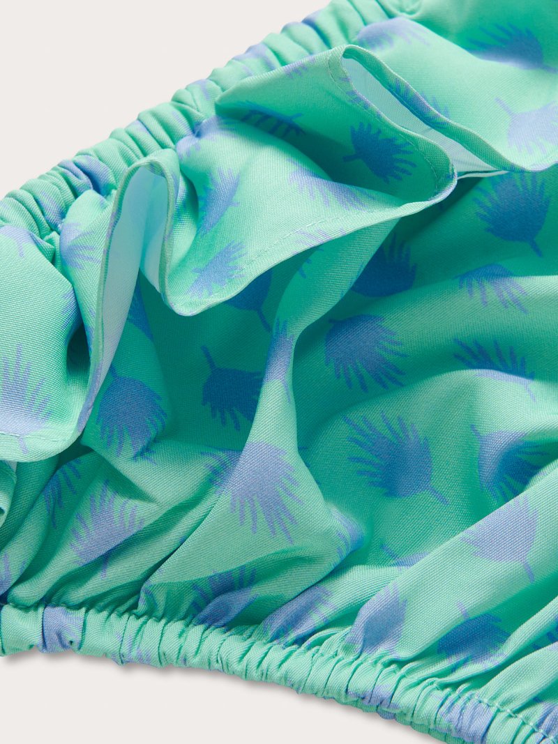Close-up view of Girls Palm Days Calabash Bikini Bottoms by Love Brand & Co. Pastel green and purple girls swimwear.
