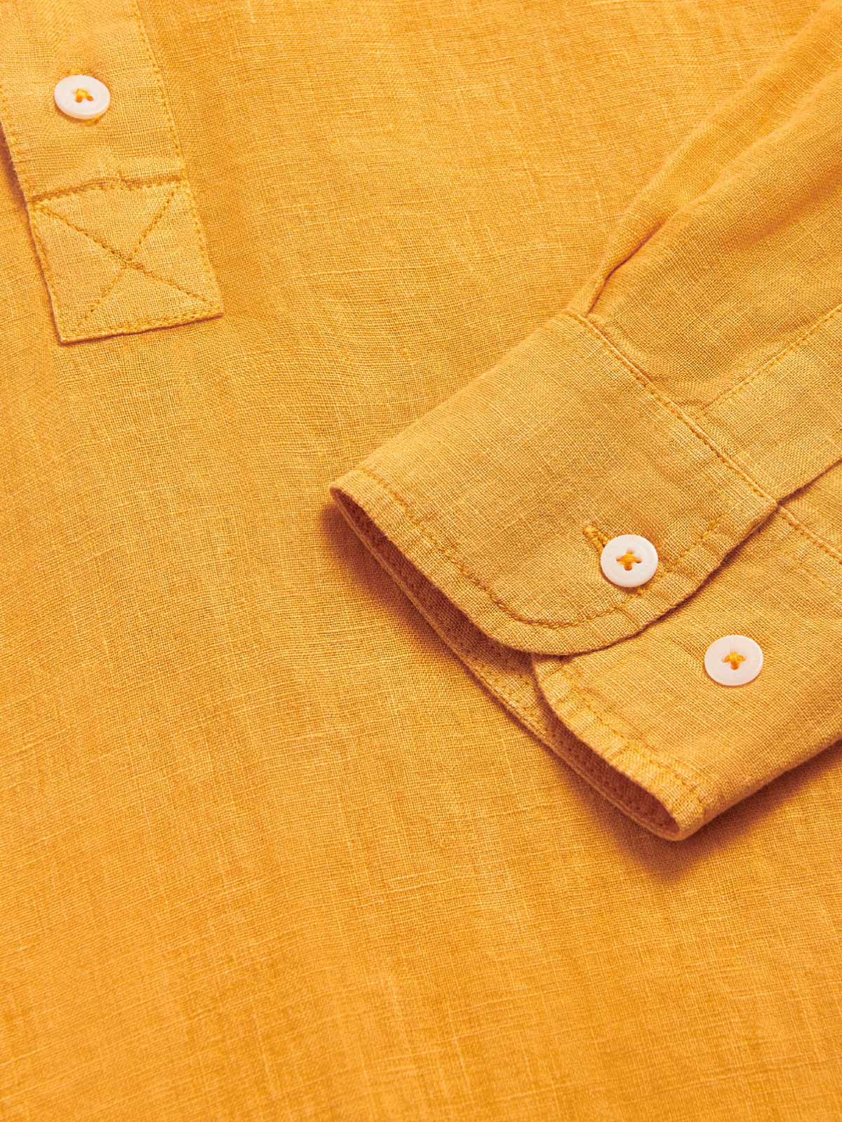 Close-up view of the sleeve and button detail on the Men's Golden Hour Hoffman Linen Shirt in a vibrant mustard colour.