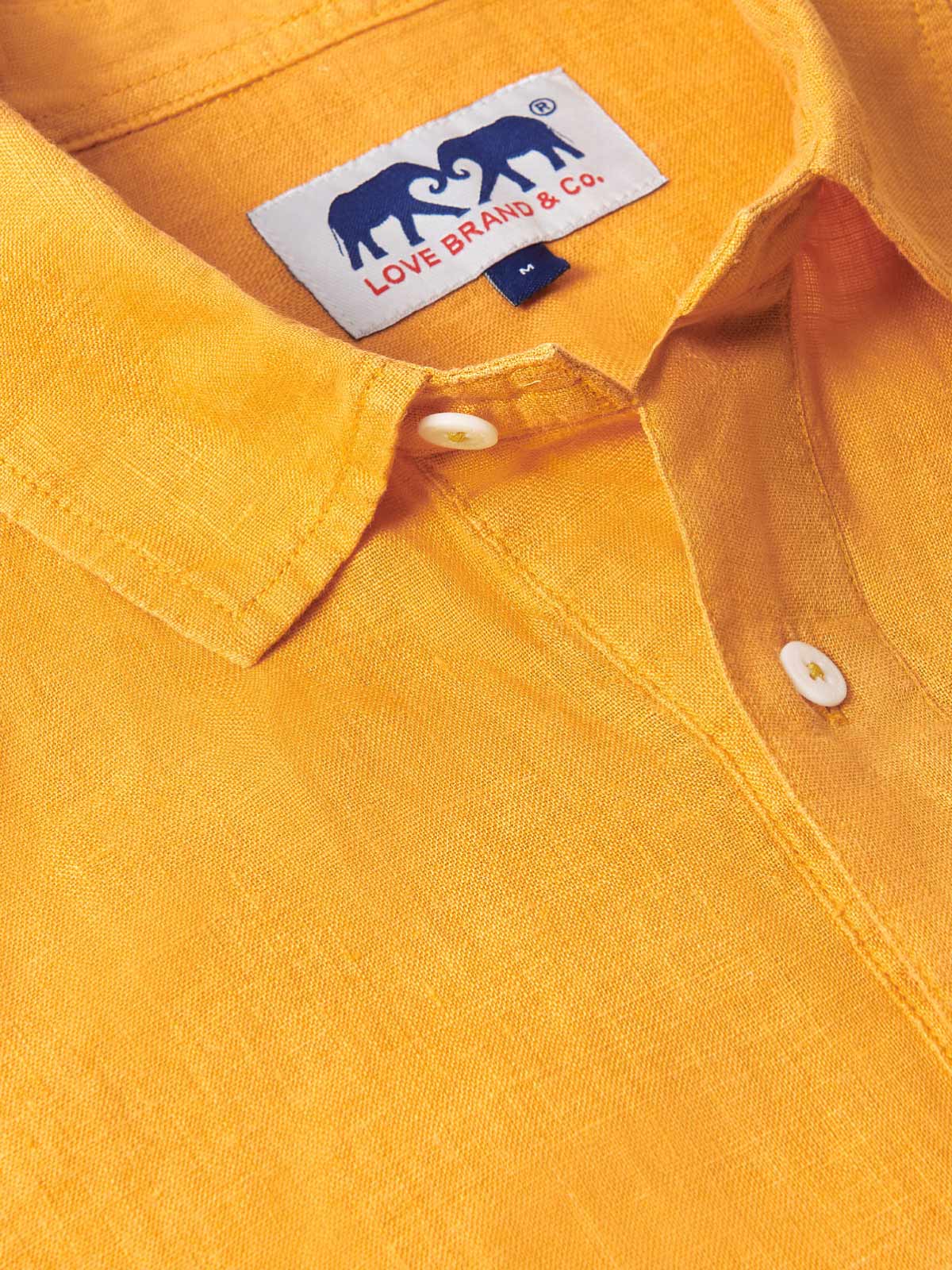 Men’s Golden Hour Hoffman Linen Shirt in vibrant yellow with a half-buttoned design and a label from Love Brand & Co.