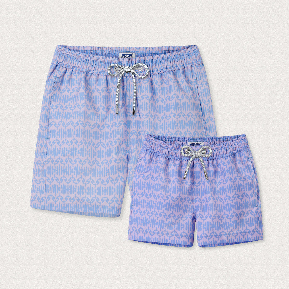 Two pairs of blue and pink geometric swim shorts