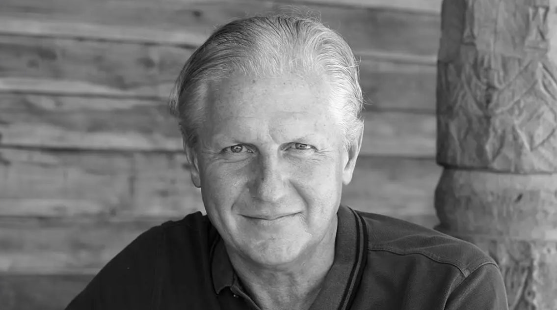 Black and white portrait of James McBride with a wooden background