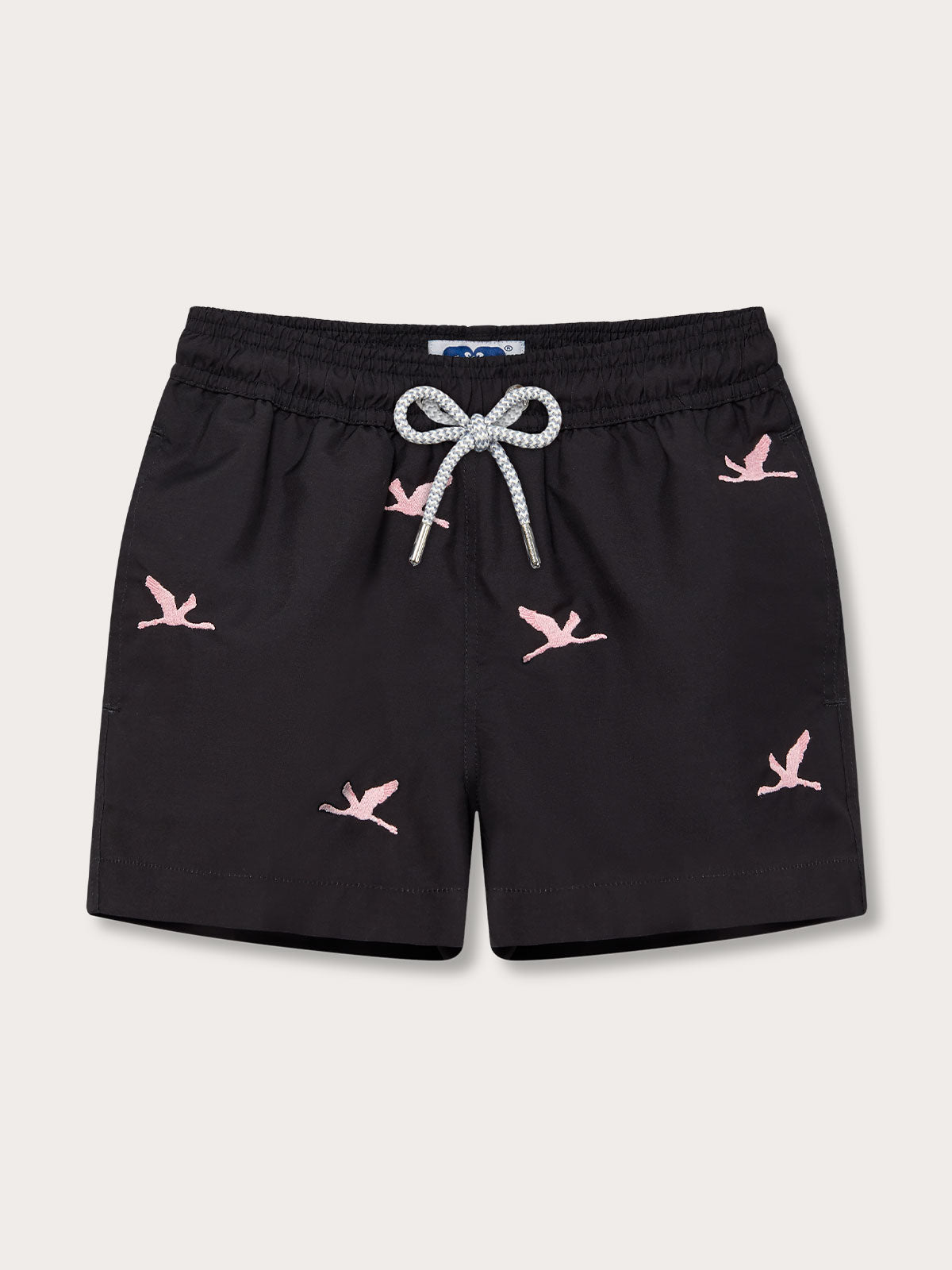 Boys Lake Nakuru Staniel Swim Shorts in black with pink flamingo patterns and drawstring waist.