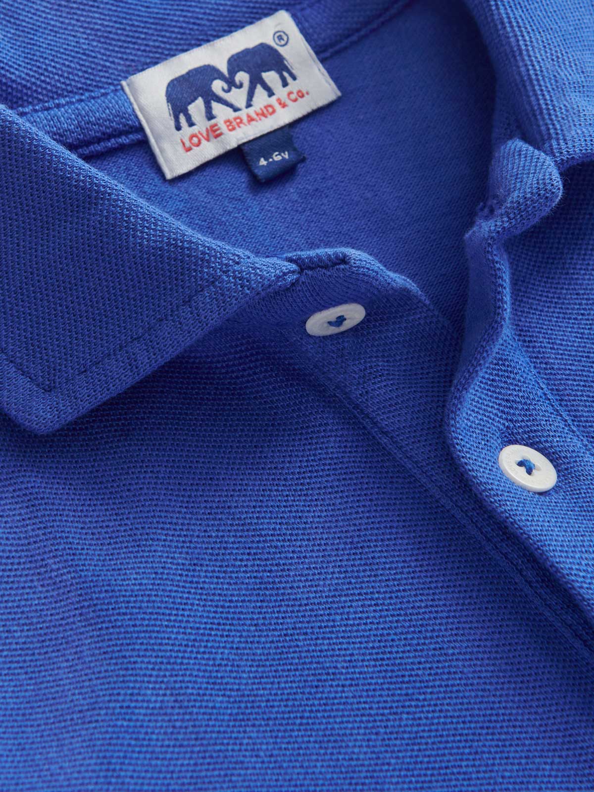 Detailed view of Kids Majorelle Blue Pensacola Polo Shirt showcasing collar and love brand logo label.