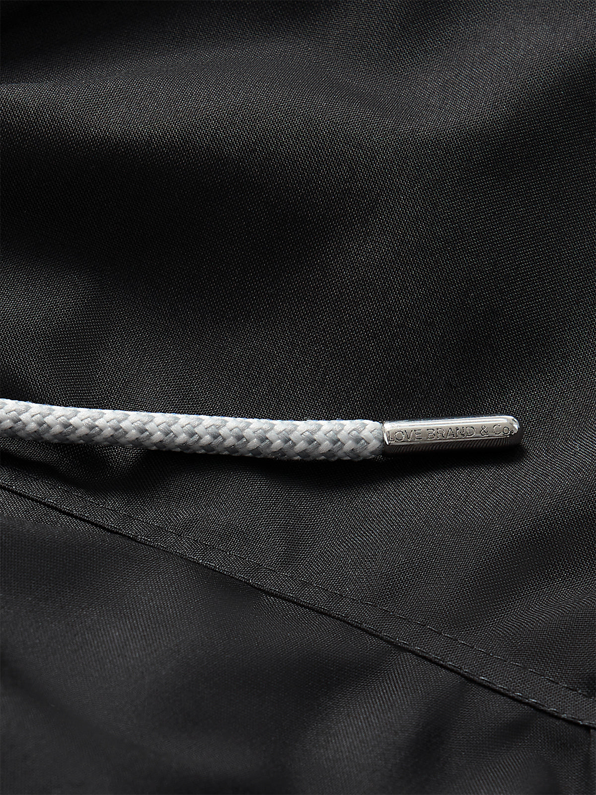 Close-up of drawstring and fabric of Boys Volcanic Black Staniel Swim Shorts.
