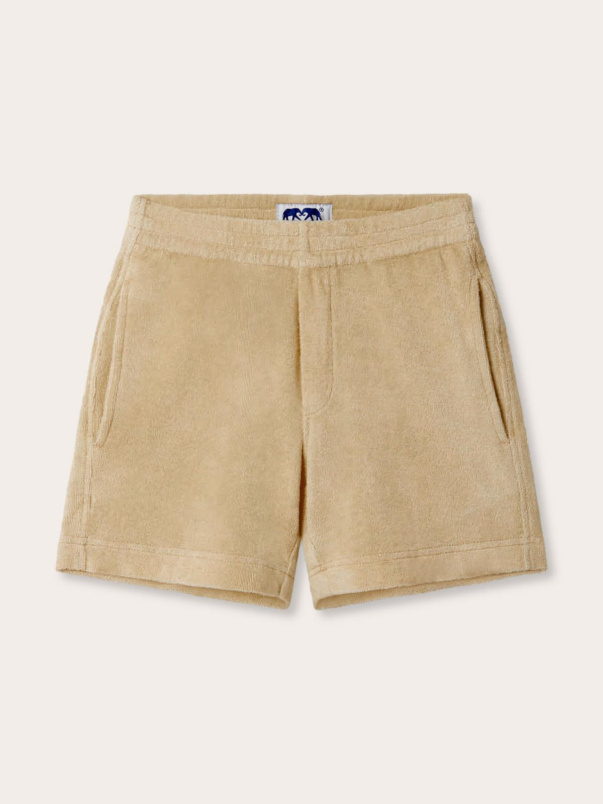 Front view of Kids Coconut Holmes Terry Shorts. Children's beige shorts with 2 front pockets.