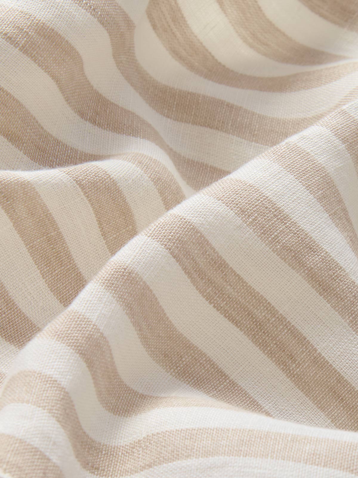 Detailed view of kids beige and white shorts