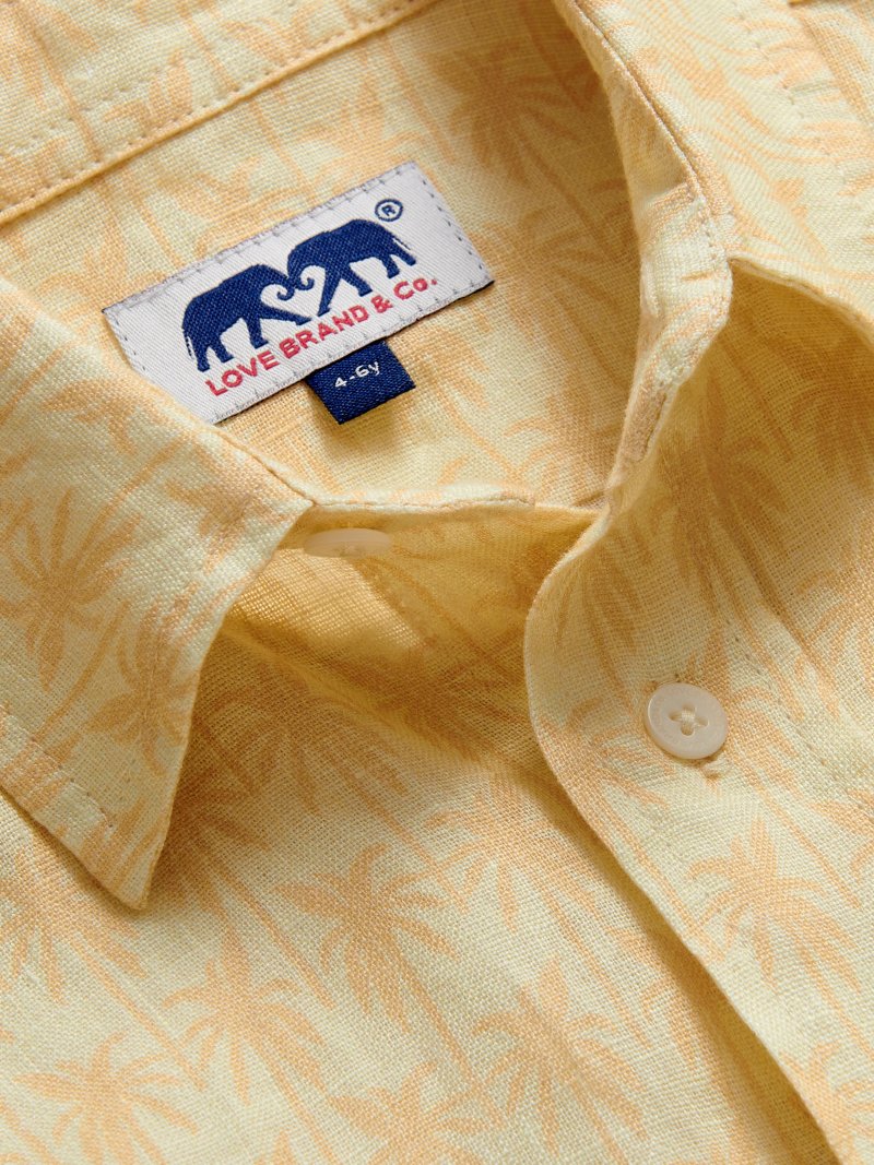 Detailed view of Kids Palm Sundowner Abaco Linen Shirt. Orange and yellow patterned long-sleeved shirt.