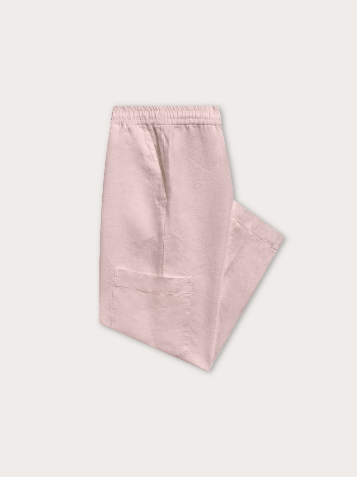 Folded view of Kids Pastel Pink Eleuthera Linen Trousers. Crafted from 100% linen.