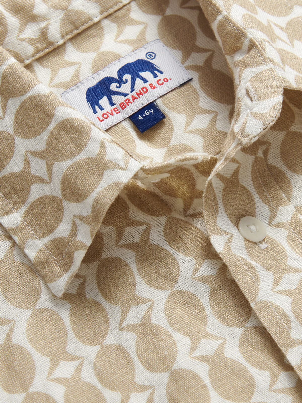 Detailed view of Kids Pina Colada Abaco Linen Shirt shocasing coconut and fish pattern.