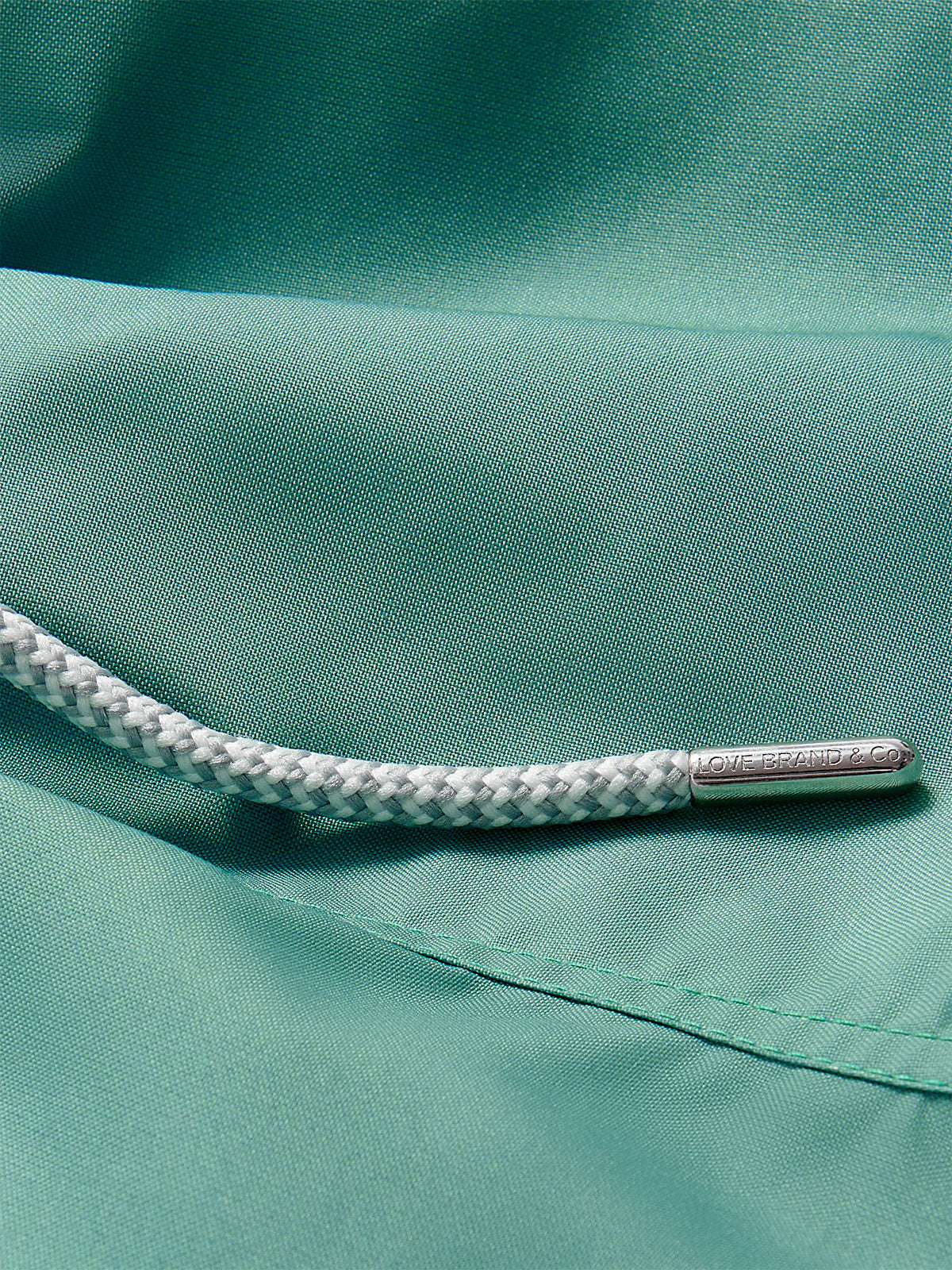 Close-up view of Boys Riviera Green Staniel Swim Shorts detailing quick-dry fabric and drawstring.