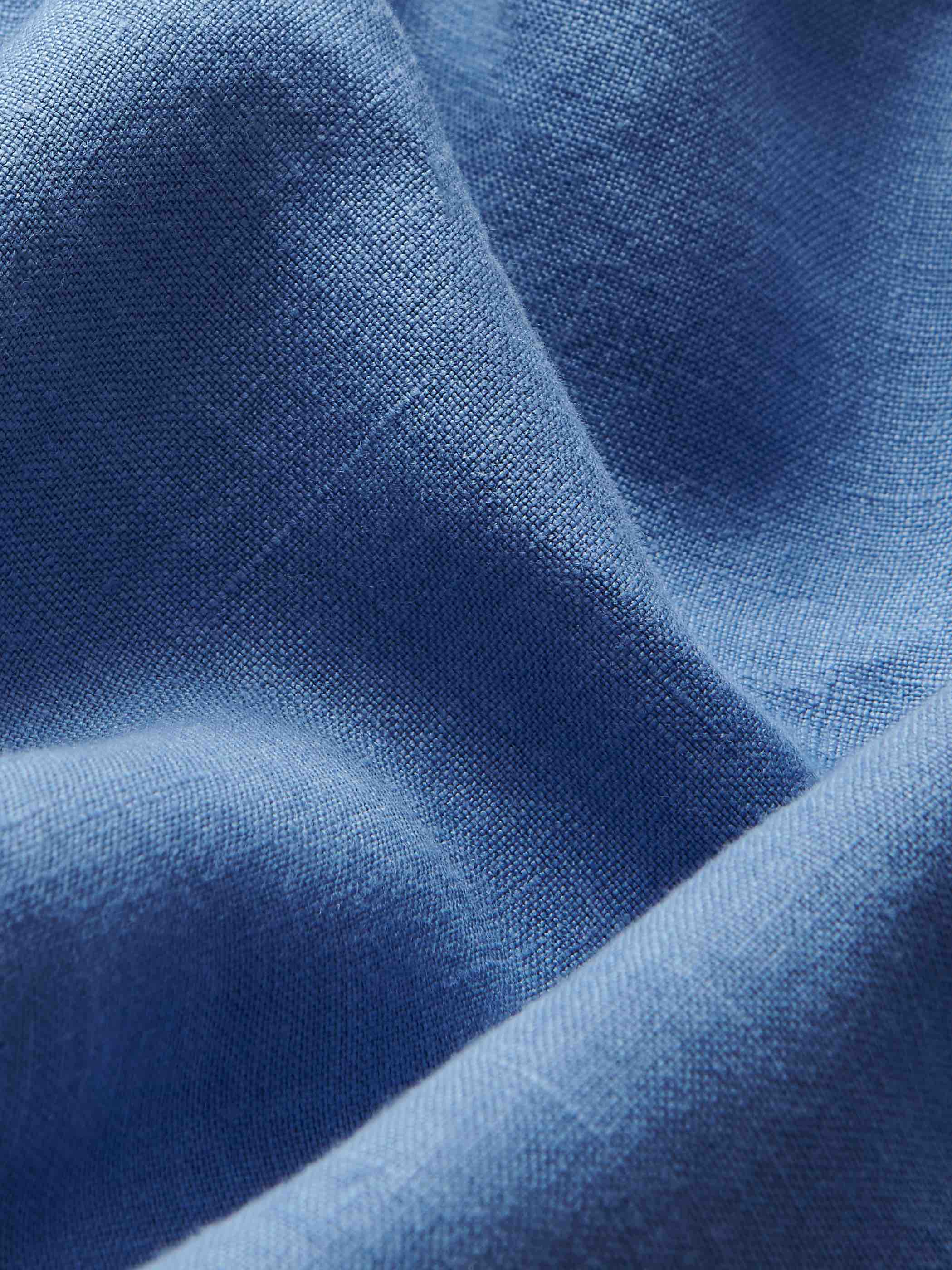 Closeup view of the 100% linen fabric of these blue mens shorts