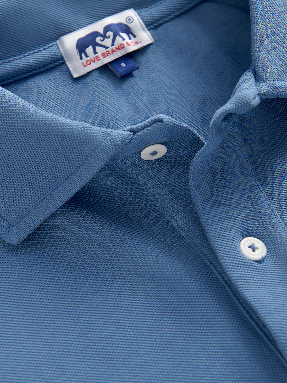 Close-up view of the collar of a mens blue polo shirt