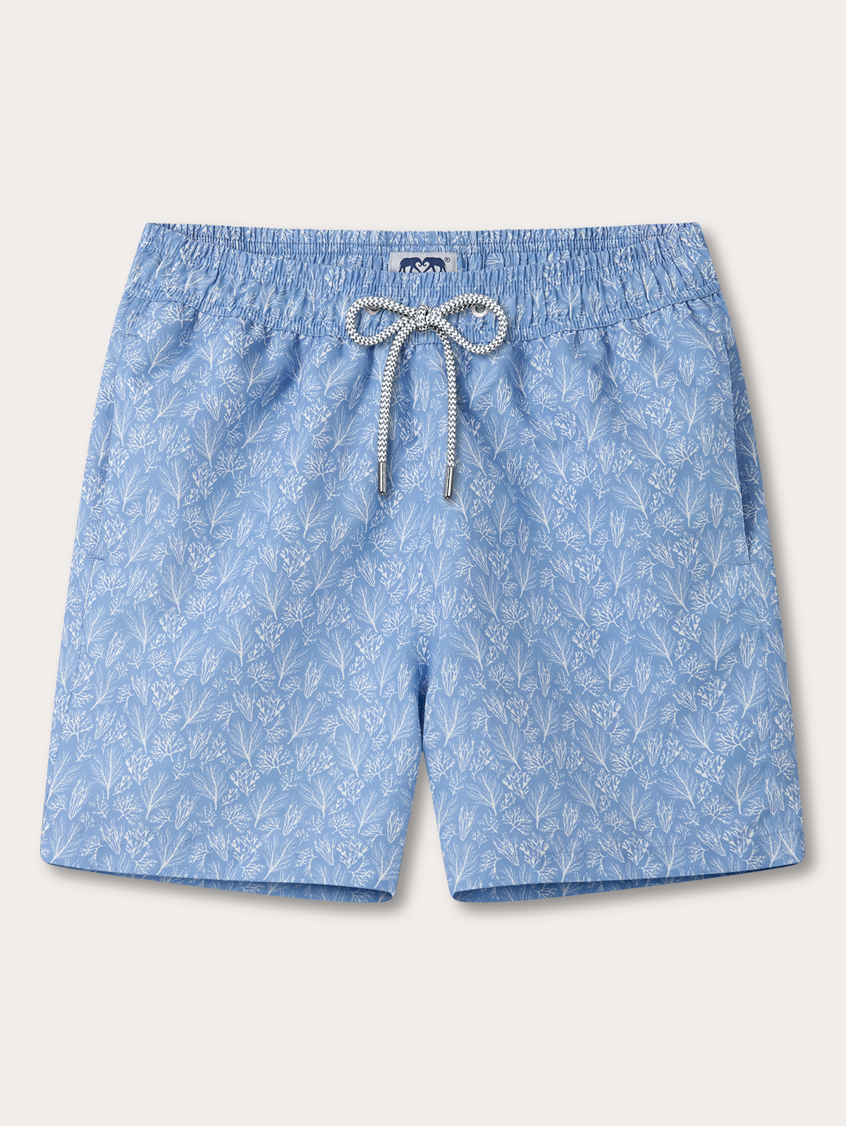 Light blue patterned swim shorts with an elastic waistband and a white drawstring, shown flat against a light beige background.
