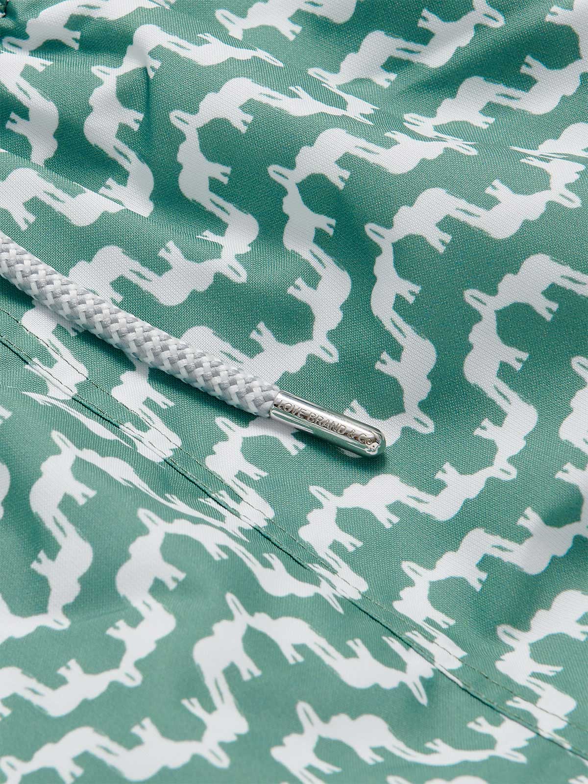 Detailed view of Men's Elephant Palace Green Staniel Swim Shorts. Green swimming shorts with elephant design.