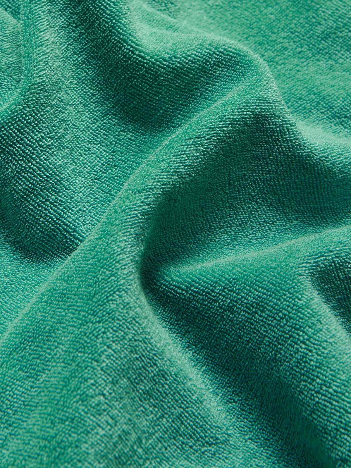 Close-up texture of the Men's Riviera Green Holmes Terry Shorts made from 100% organic cotton.