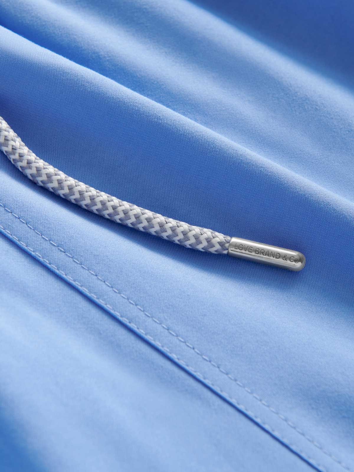 Detailed view of Men's Ocean Blue Staniel Swim Shorts showing blue recycled fabric and drawstring.