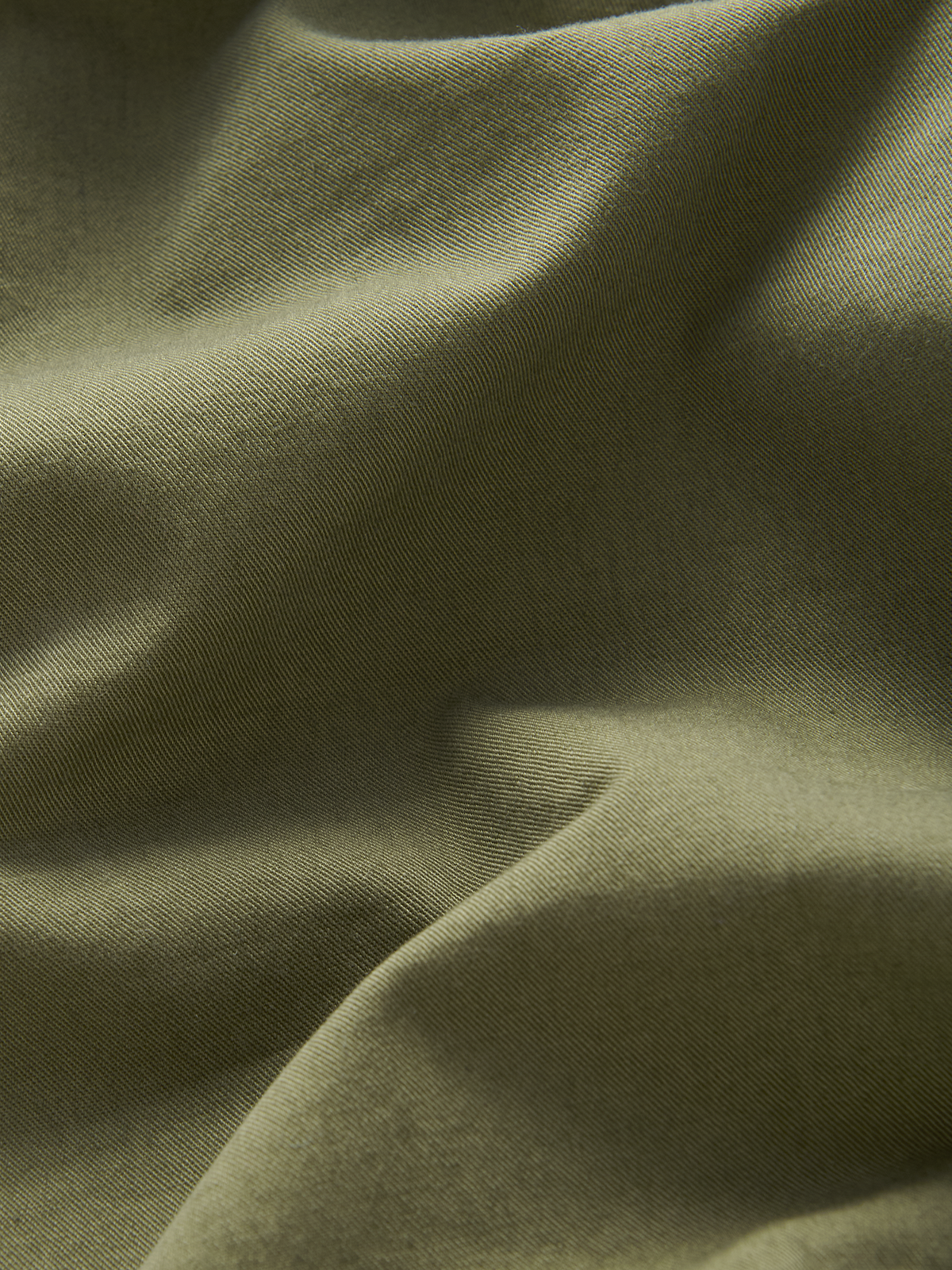 Close-up of green cotton fabric with visible texture