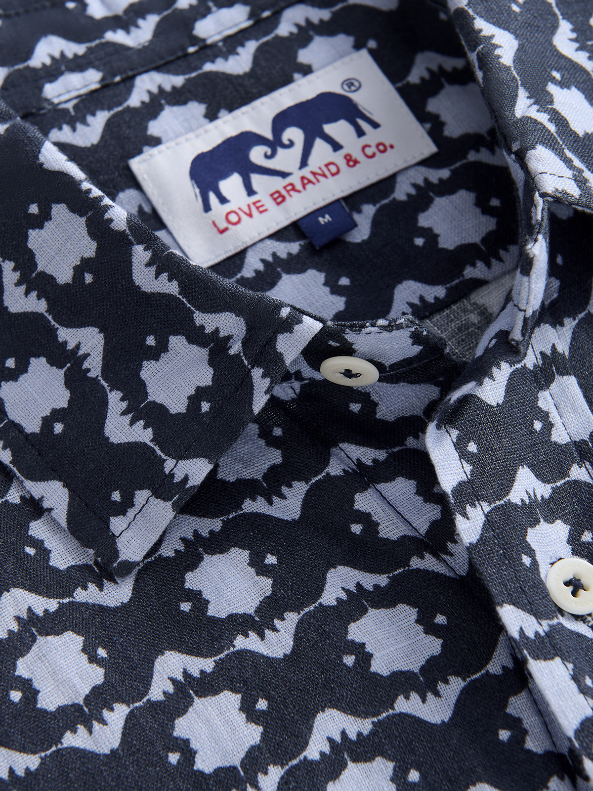 Close-up of a patterned shirt with a visible love brand label.