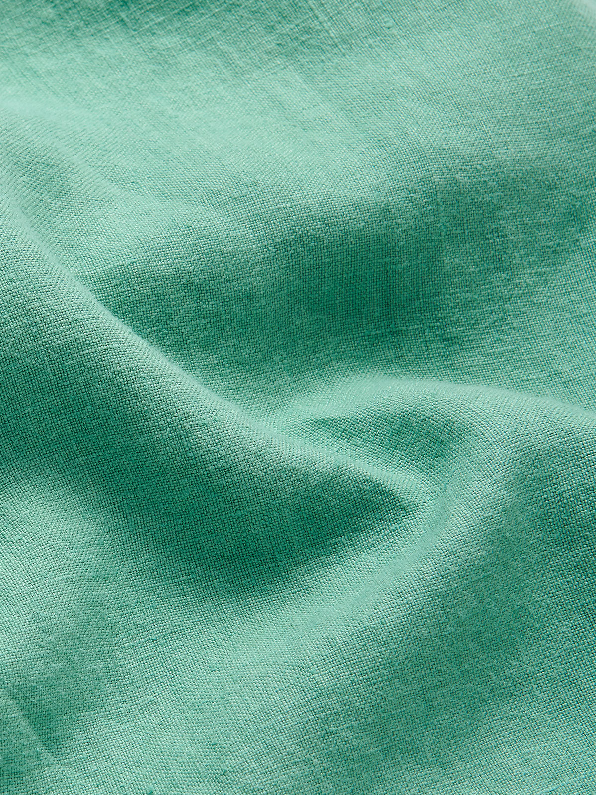 Close-up of the fabric texture of the Men's Riviera Green Burrow Linen Shorts, showcasing the lightweight and breathable 100% linen material.