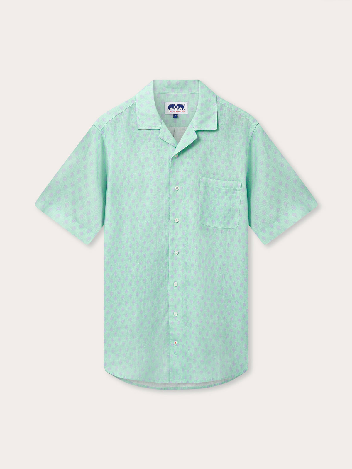 Front view of Men's Palm Days Arawak Linen Shirt. Pastel green short-sleeved linen shirt with front pocket and subtle purple palm pattern.