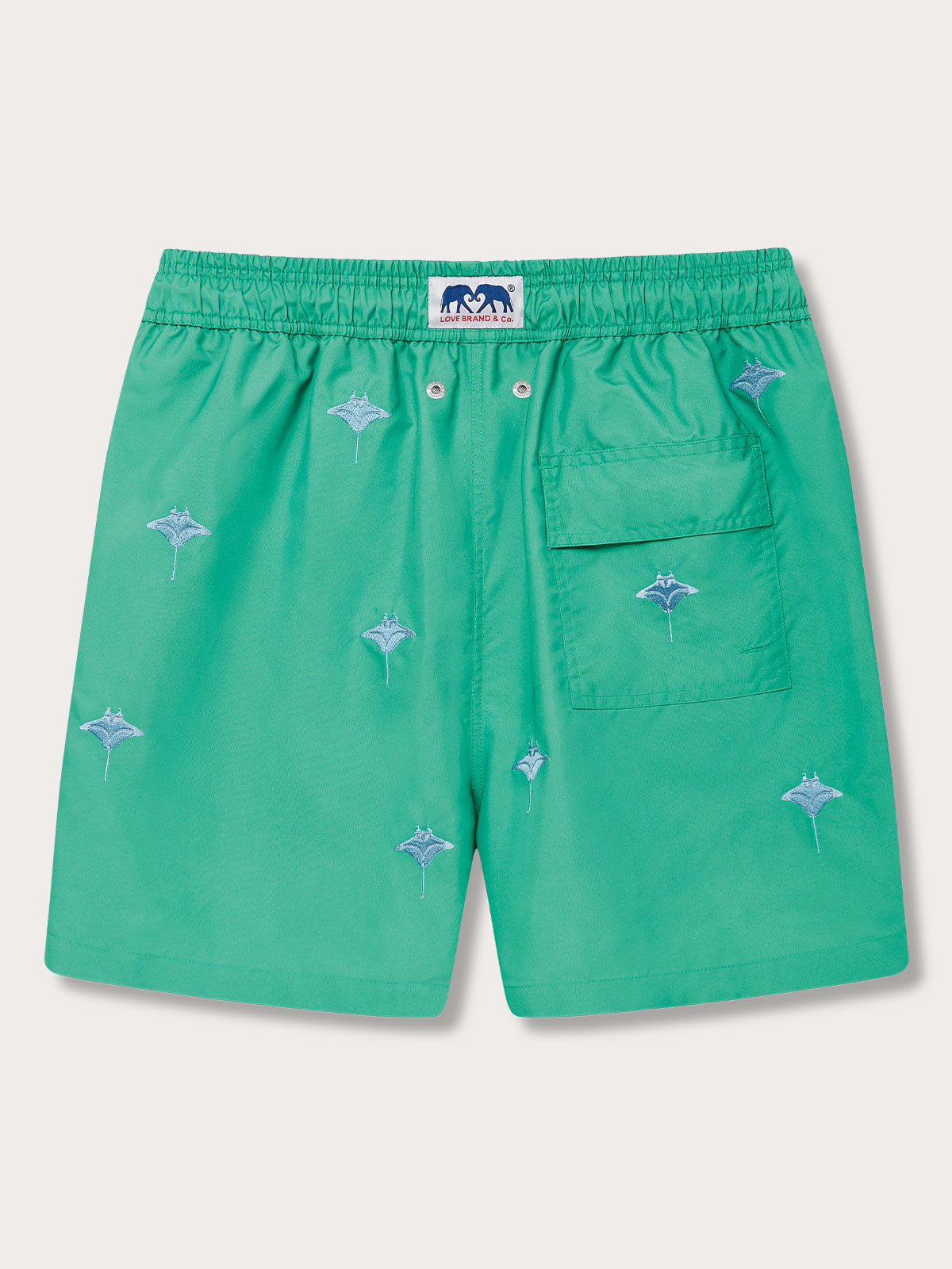 Green swim shorts with embroidered manta ray design, elastic waistband, and back pocket, "Men's Manta Migration Embroidered Staniel Swim Shorts" by LOVI Brand & Co.
