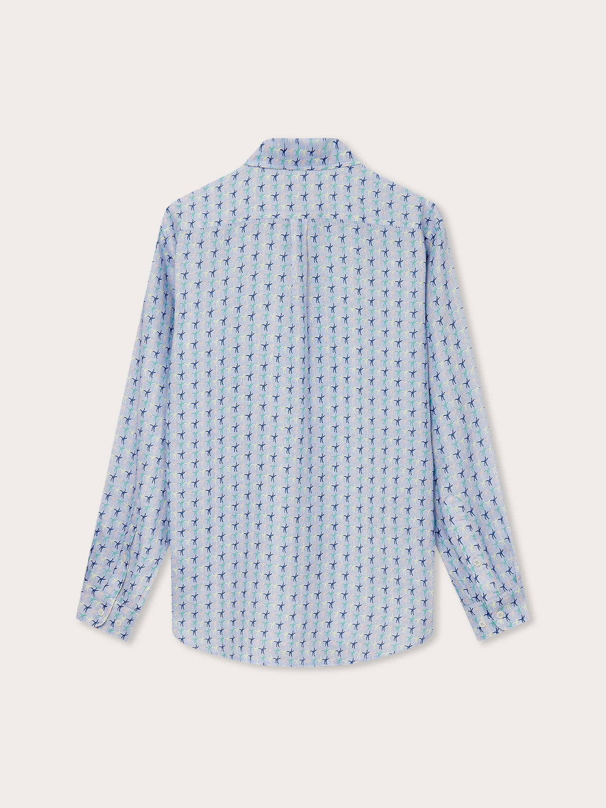 Men's Star Dancer Abaco Linen Shirt with pastel pink, limoncello, cay green, and deep blue sea star motif on an ocean blue background - back view.