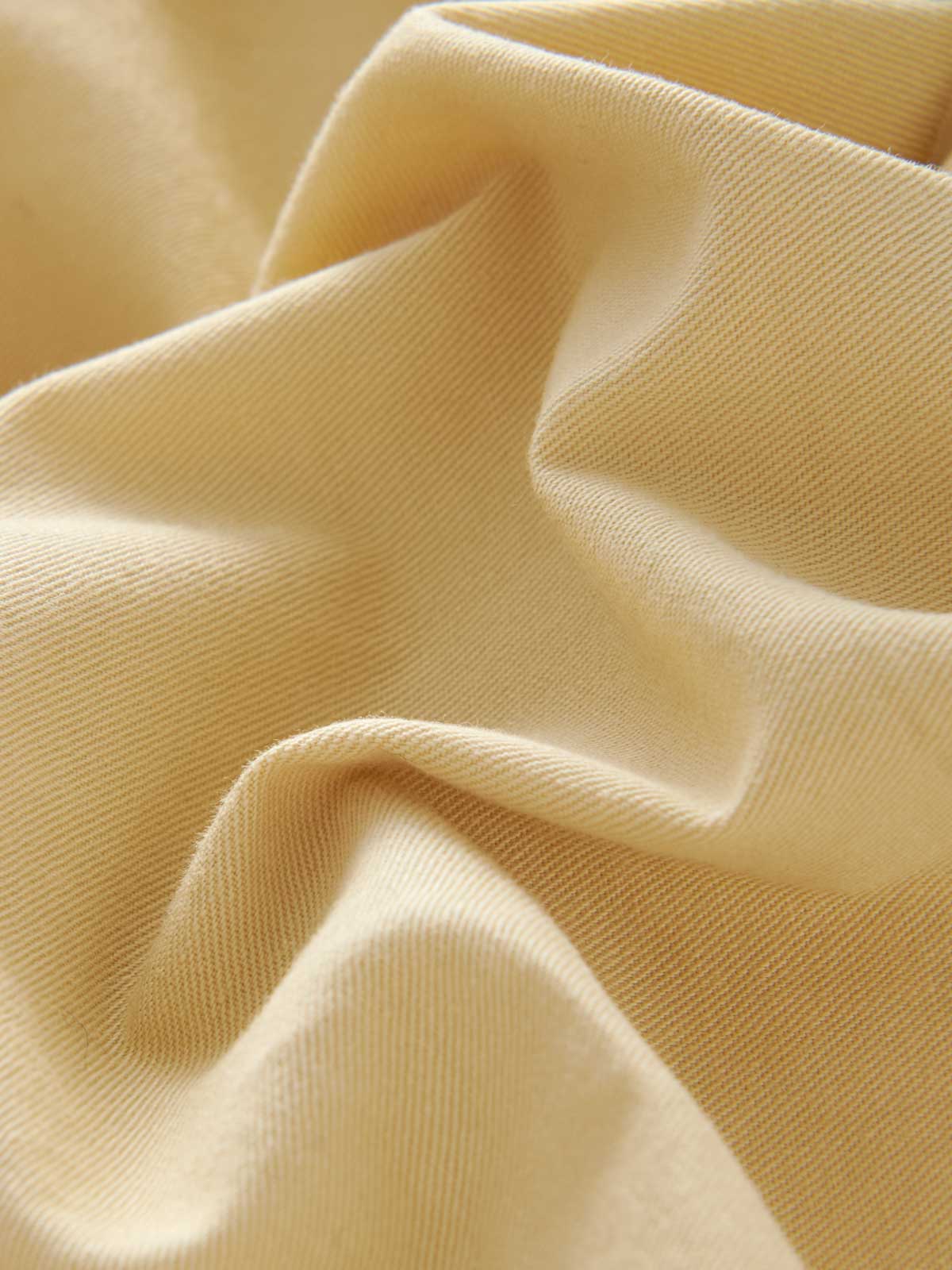 Close-up view of the beige fabric of Men's Stone Harvey Cotton Shorts by love brand.