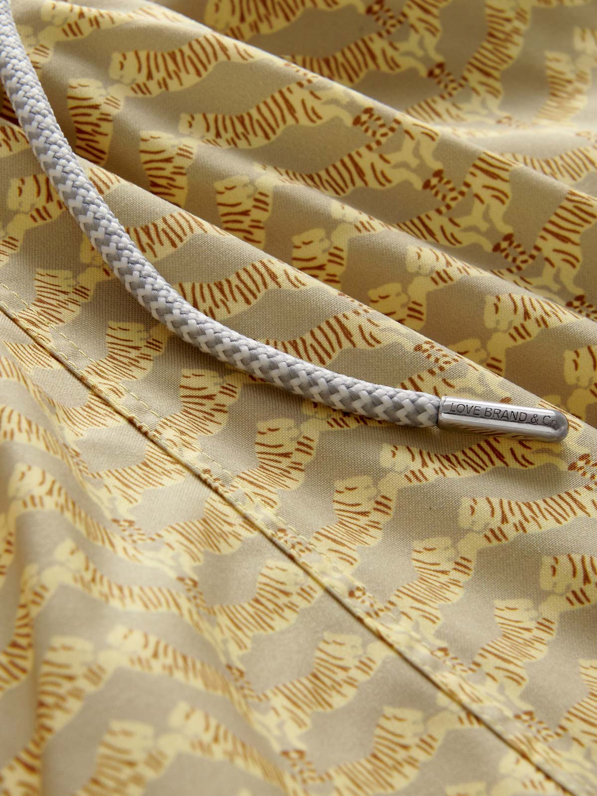 Close-up view of Men's Tiger Land Staniel Swim Shorts featuring tiger print.