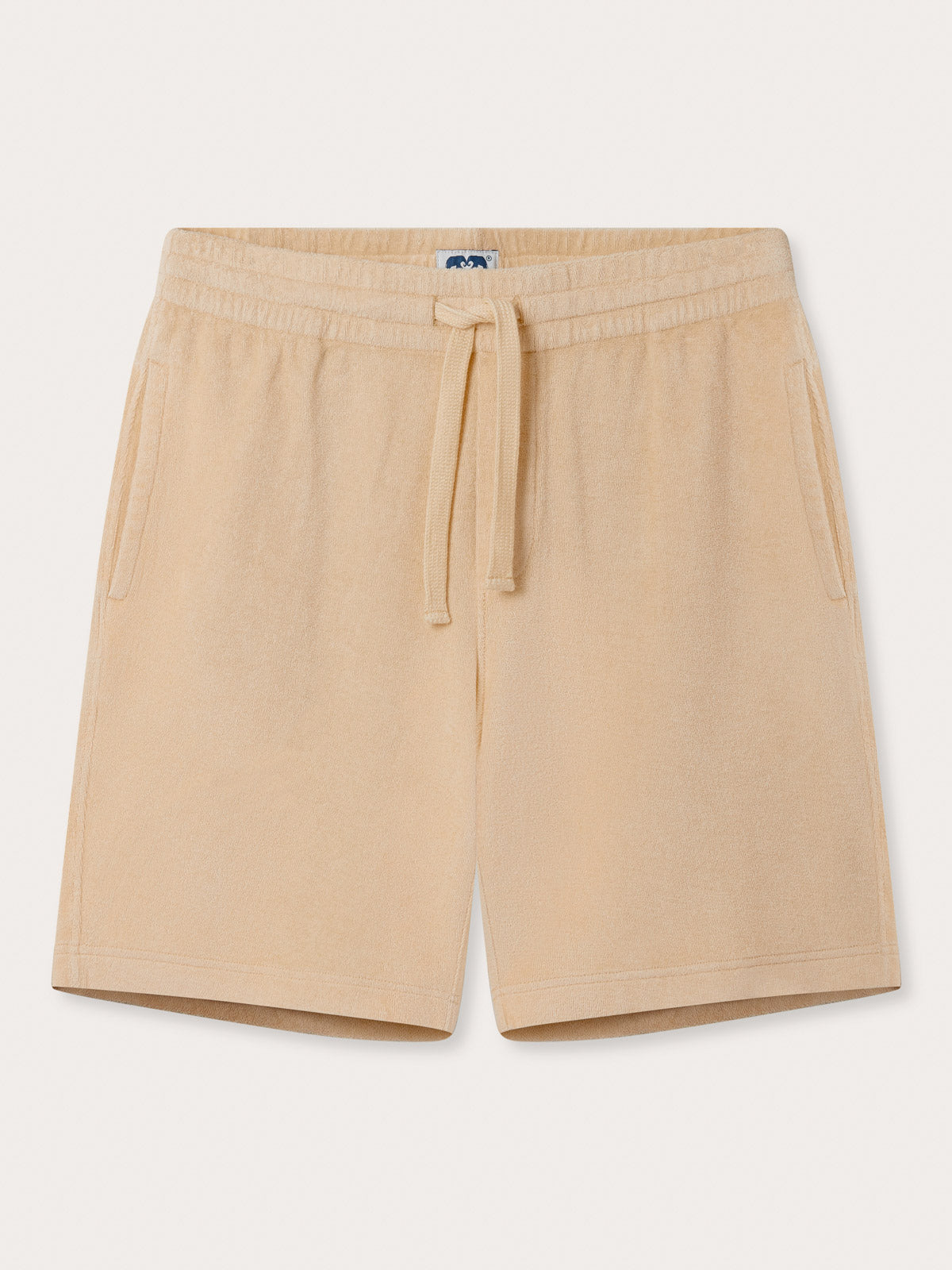 Front view of Men's Coconut Holmes Terry Shorts. Beige 100% cotton shorts with 2 front pockets. Terry towelling shorts with elastic waist and drawstring tie.