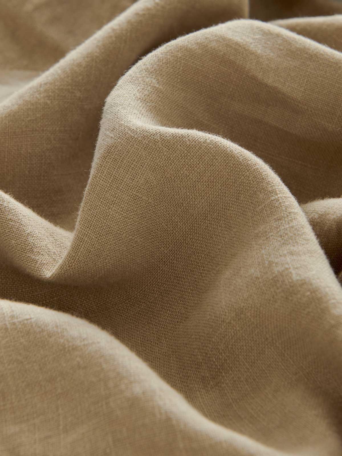 Close-up fabric view of Men's Coconut Randall Linen Trousers. Beige 100% linen fabric.