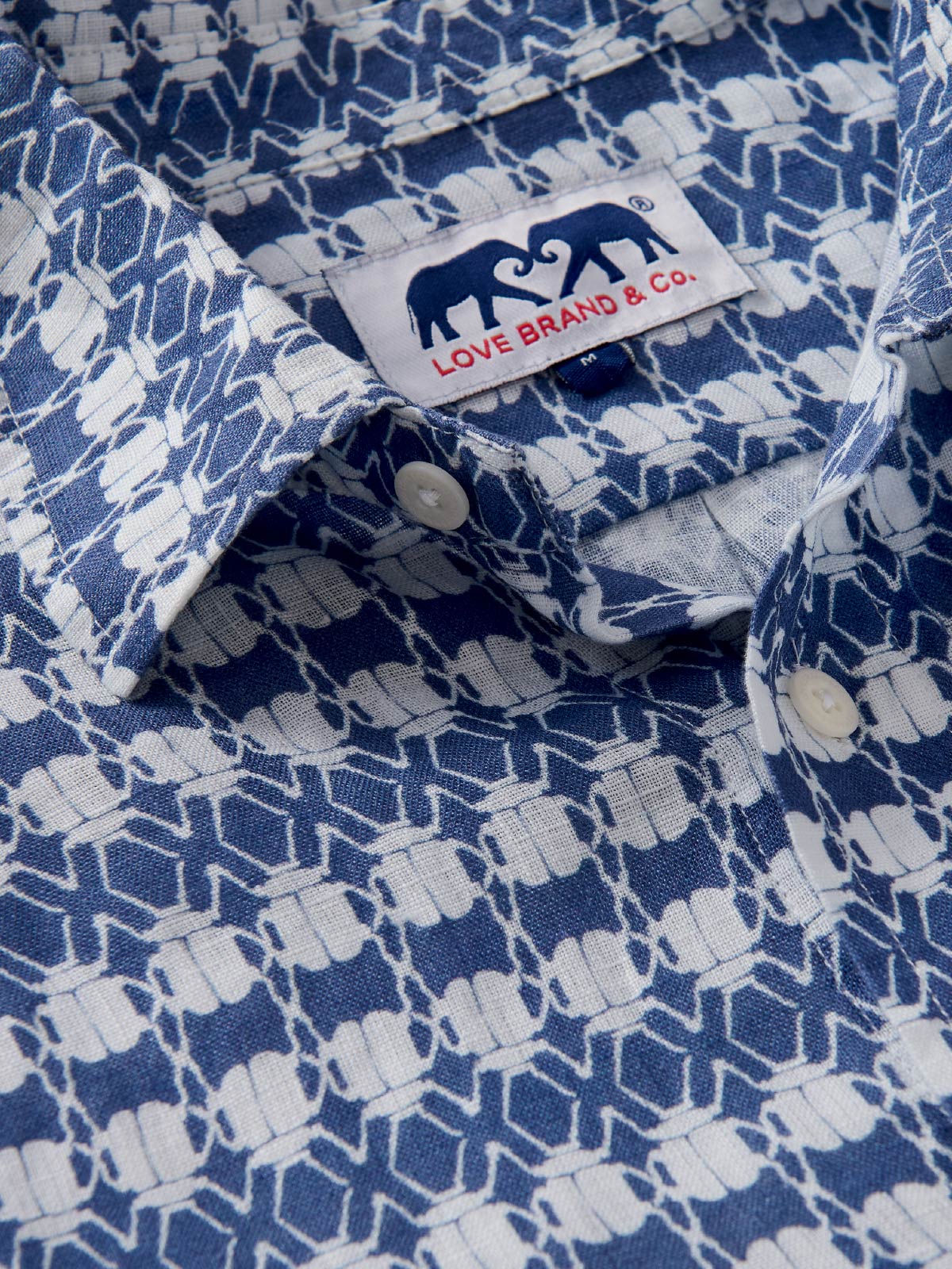 Close-up of a blue and white patterned shirt with a visible love brand label.