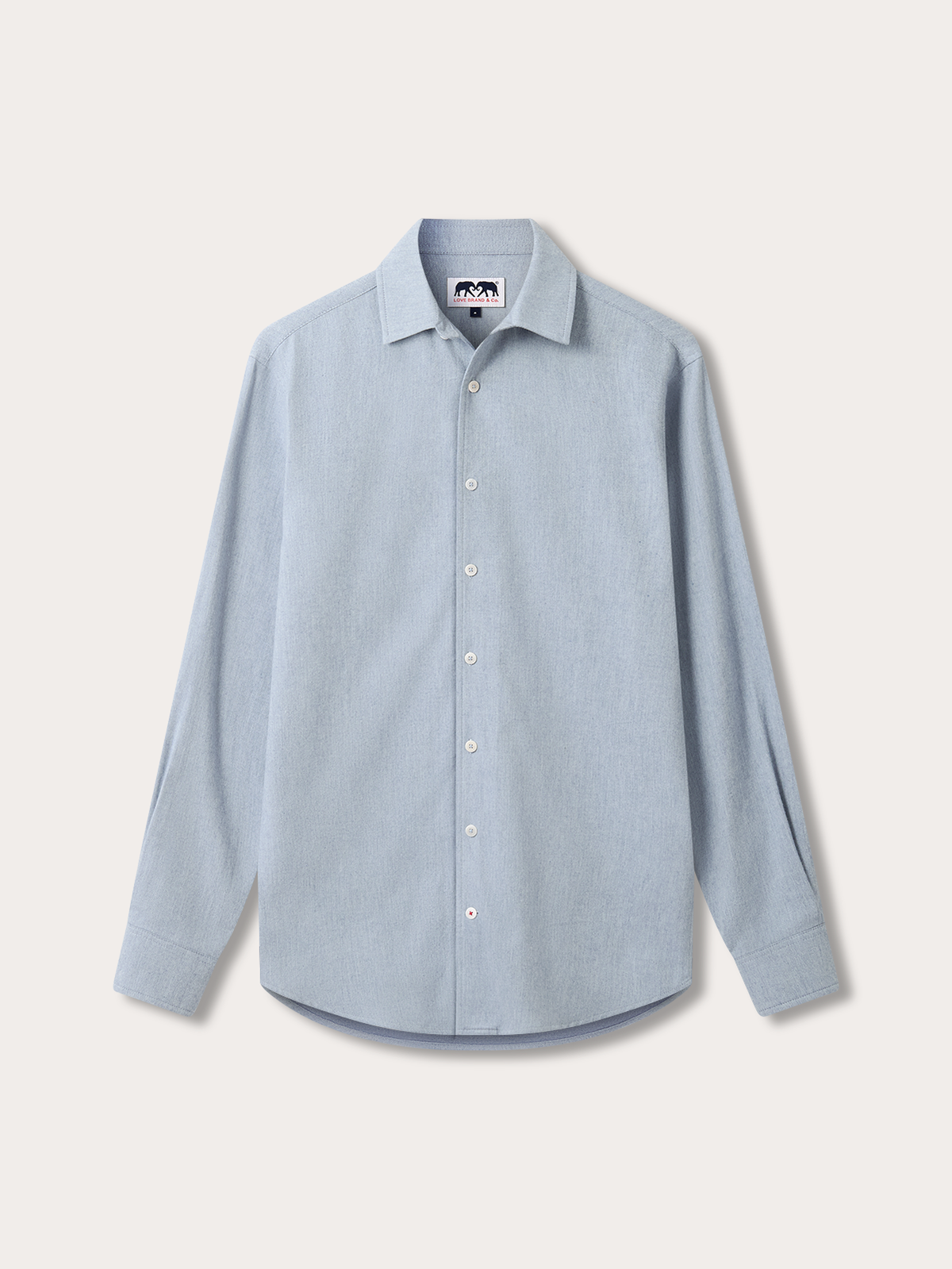 A light blue long-sleeve button-down shirt with a classic collar, laid flat against a light beige background.