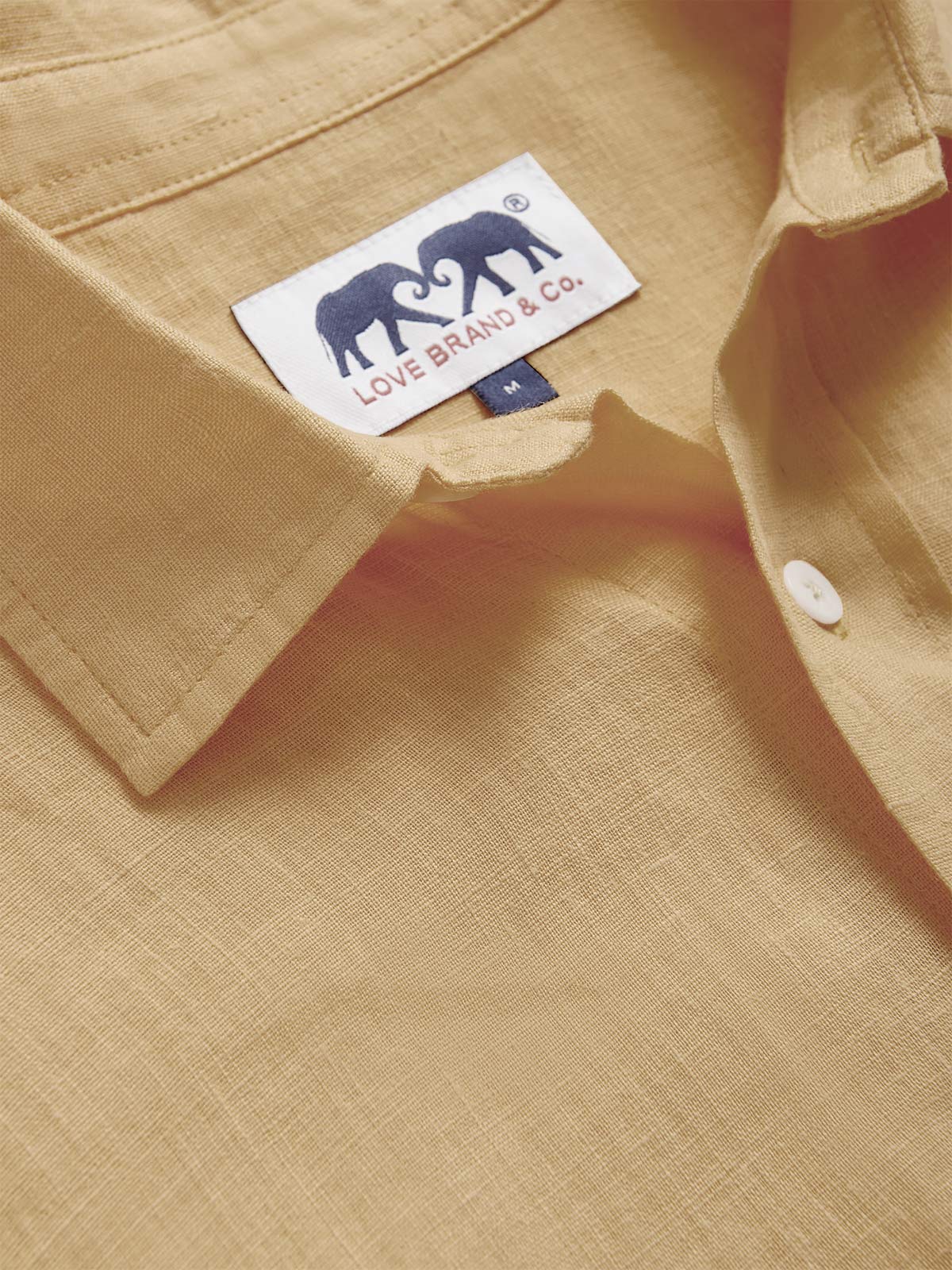 Collar view of Men's Coconut Abaco Linen Shirt. 100% linen shirt in a beige colour showcasing Love Brand logo.