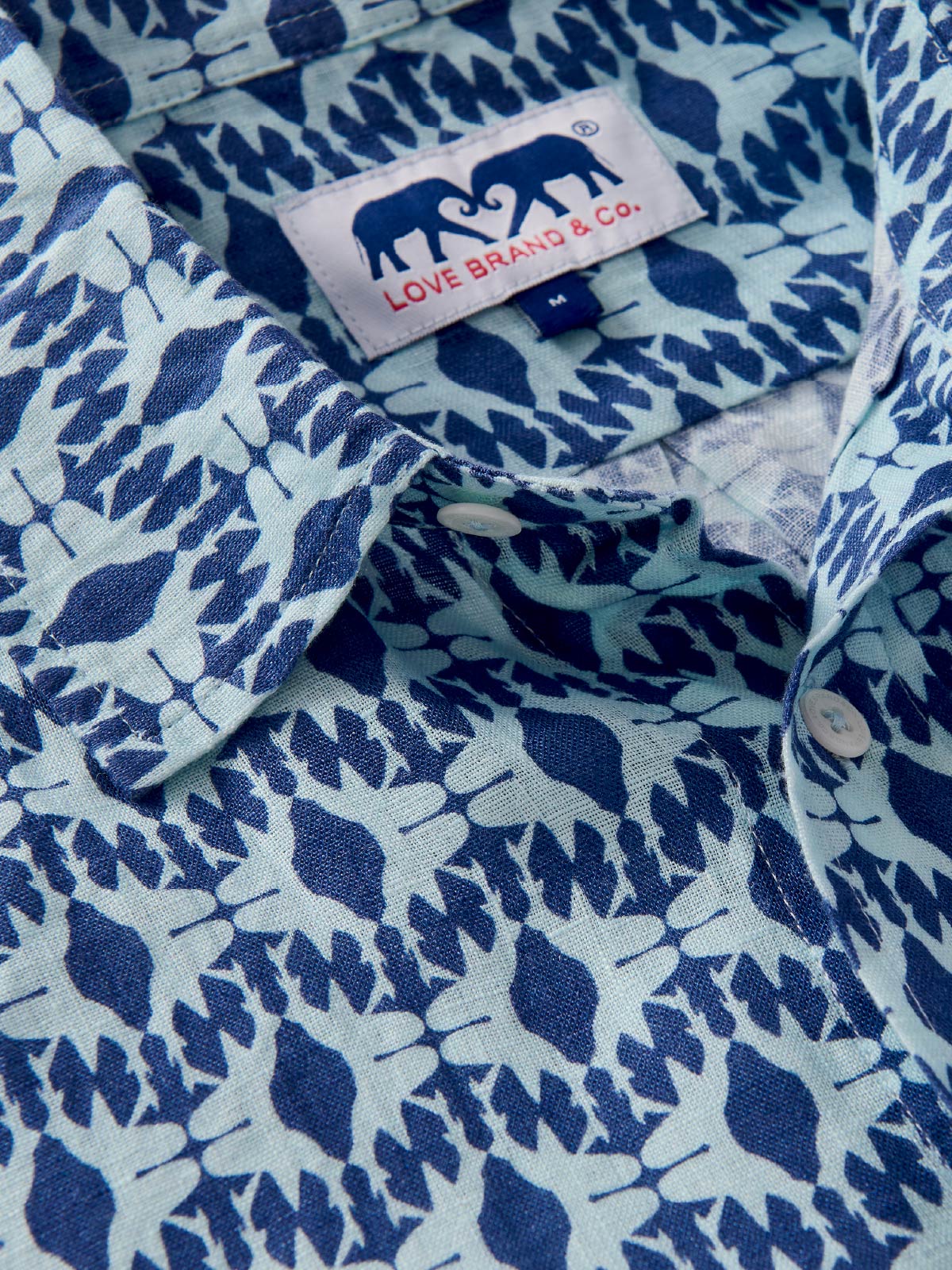 Close-up of a blue patterned shirt with a visible love brand label.