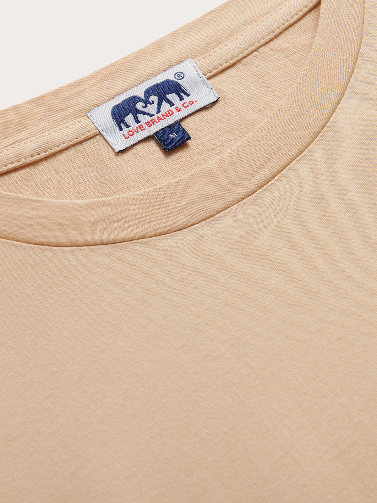 Detailed view of Men's Coconut Lockhart T-Shirt collar showing love brand & co. logo.