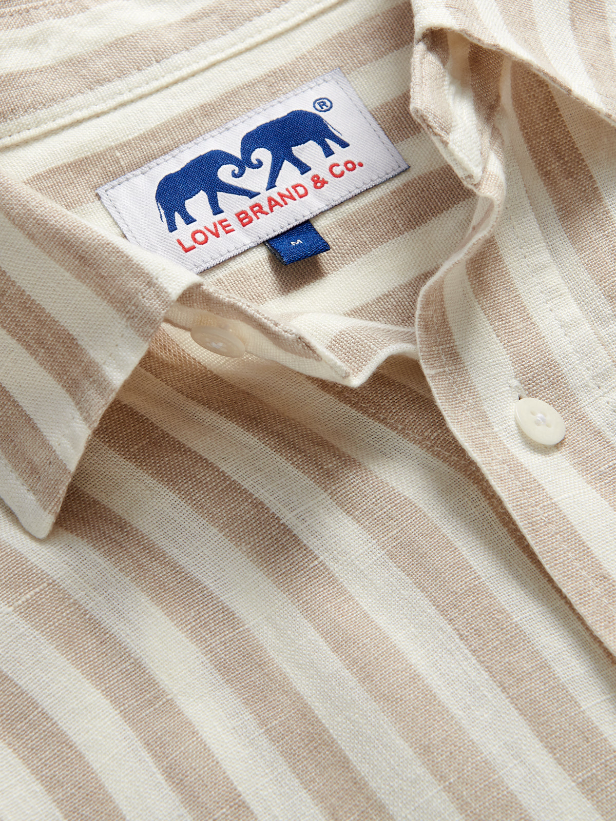 Close-up view of the collar of Men's Coconut Stripe Abaco Linen Shirt showing Love Brand logo.