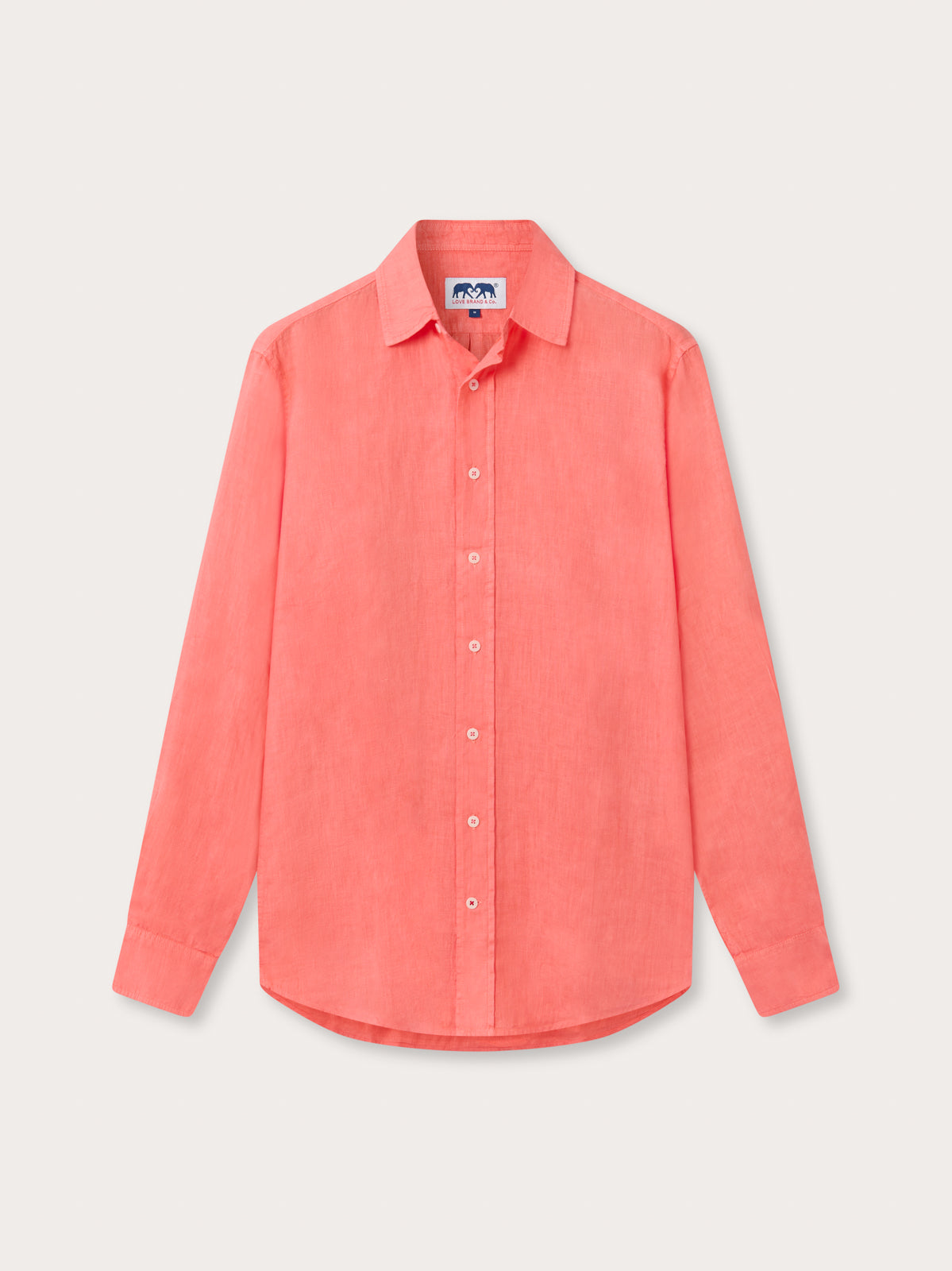 Front view of Coral pink linen shirt on beige background